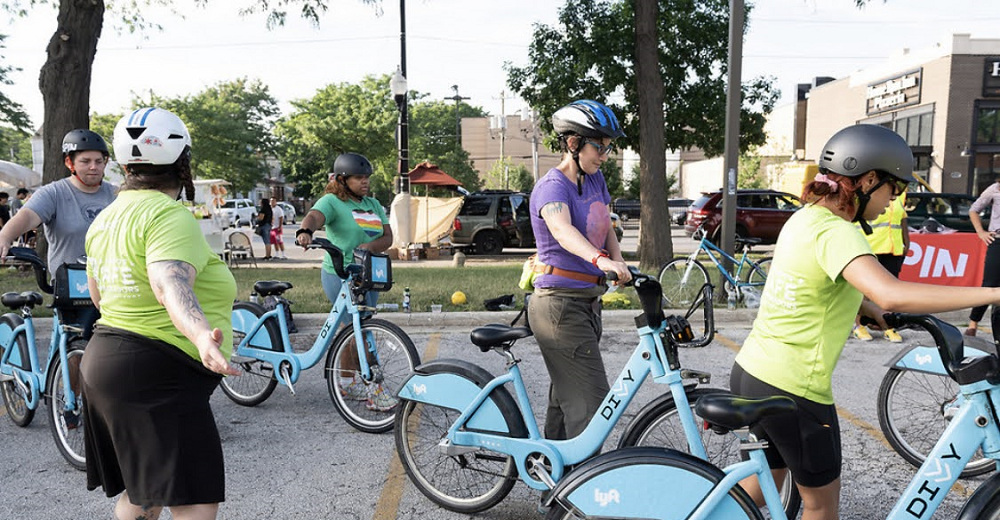 A group walking with  bikes at a Learn to Ride class