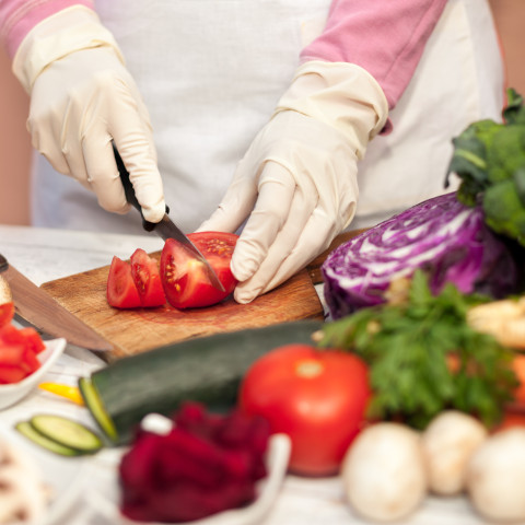 food preparation - cutting tomato on wood cutting boare