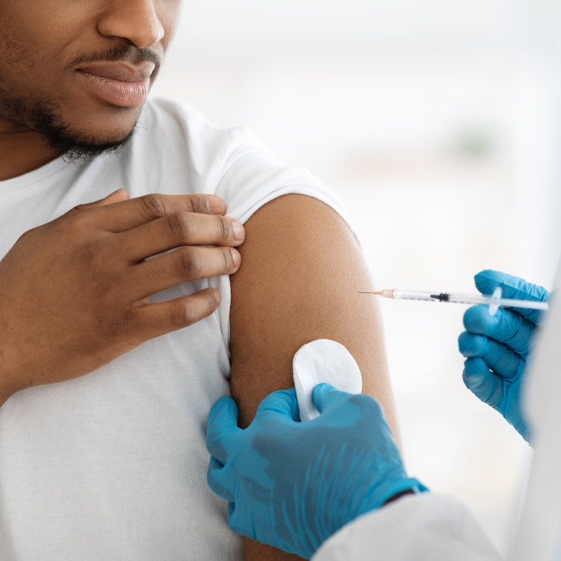 young man receiving shot in upper arm