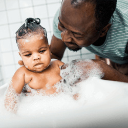 Healthy Families menu image - father giving infant a sudsy bath