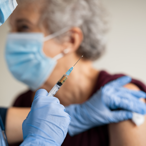 elderly woman receiving immunization