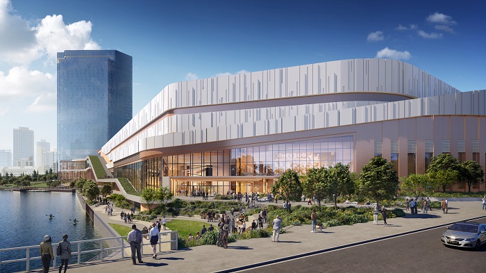 Image of the project from Chicago Ave looking down the river walk. Shows the casino building, Bally’s landing park space, riverwalk, and the hotel tower.