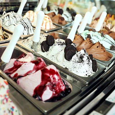 Multiple flavors of Gelato on display in a shop.