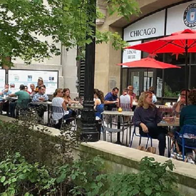 Table with people dining outdoors.