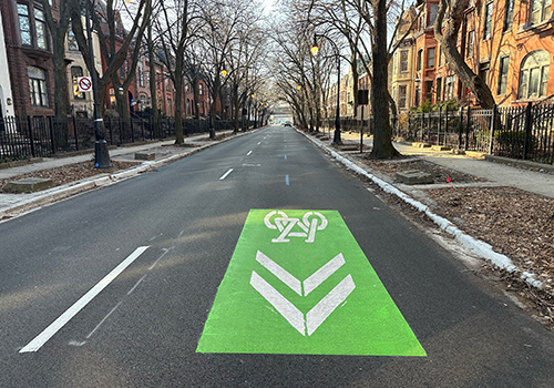 Street with bike symbol markings on the roadway