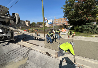 Image of a construction crew pouring concrete