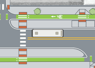 CTA bus stopped at bus stop with a concrete bus boarding island separating the travel lane from green painted bike lane.