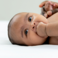 crying woman with baby in lap