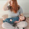 crying woman with baby in lap