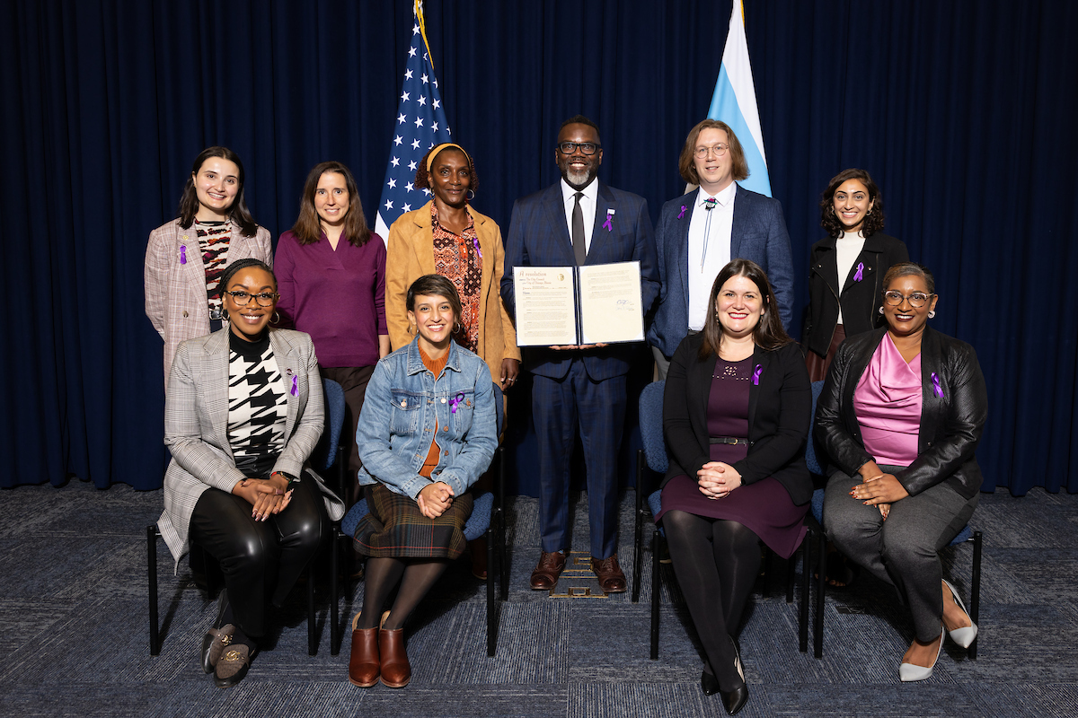 Gender Based Violence Task Force Member receiving resolution honoring Domestic Violence Awareness Month. Photo with task force, with Mayor in the center. 